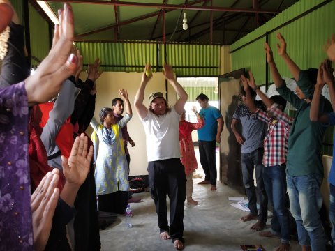 A group of people with their arms in the air